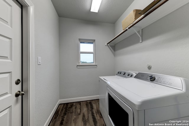 clothes washing area featuring washer and dryer, a textured ceiling, and dark wood-type flooring