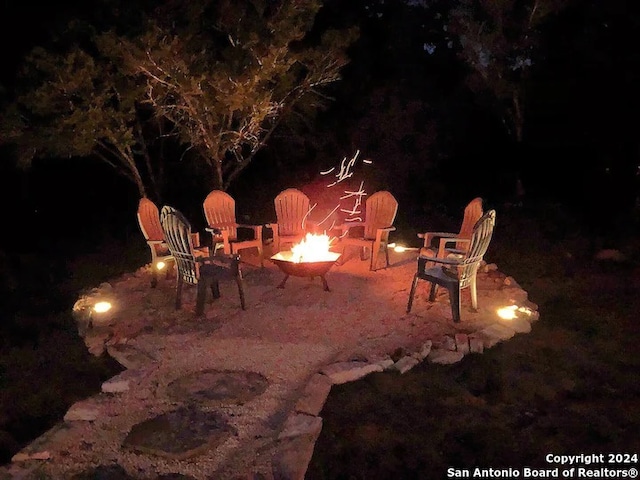 patio at night with a fire pit