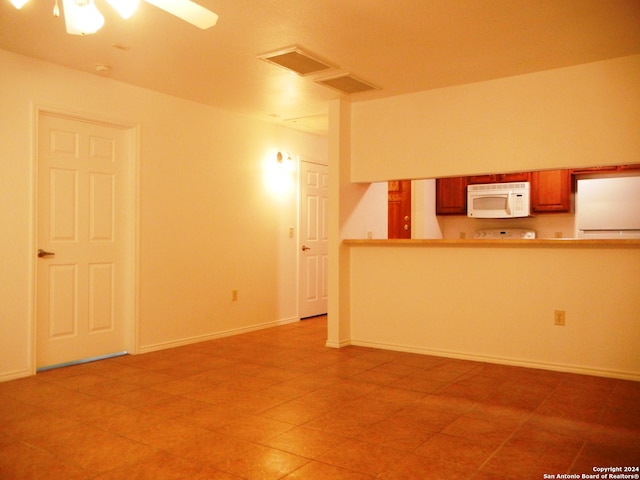 unfurnished living room featuring ceiling fan