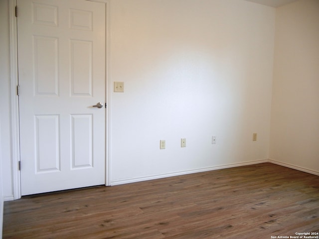 spare room with dark hardwood / wood-style flooring