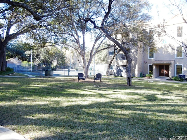 view of home's community with a yard