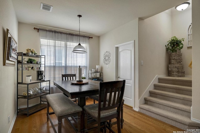 dining space featuring wood-type flooring