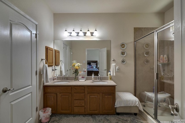 bathroom with vanity and a shower with shower door