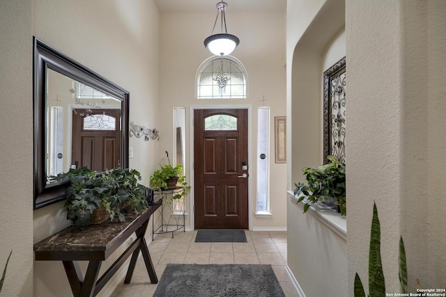 tiled entrance foyer with a high ceiling