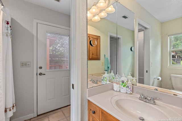 696 Faurie Rd, Lakehills, TX 78063 - bathroom featuring toilet, vanity, and tile patterned flooring