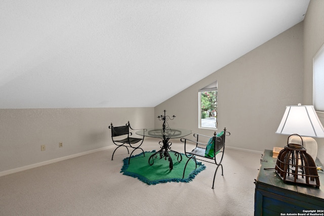 sitting room featuring vaulted ceiling and carpet