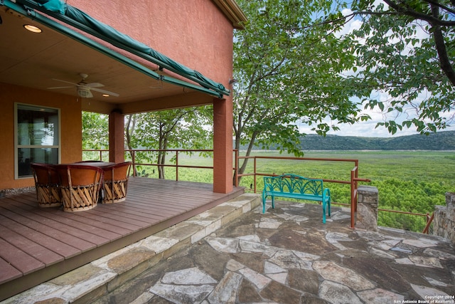 exterior space with a patio, ceiling fan, and a mountain view