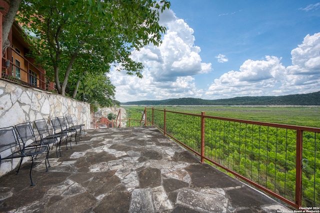 view of patio with a mountain view and a rural view