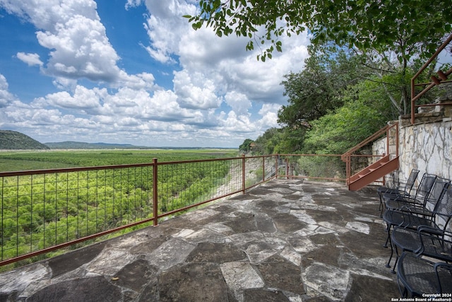 696 Faurie Rd, Lakehills, TX 78063 - view of patio with stairs and a rural view
