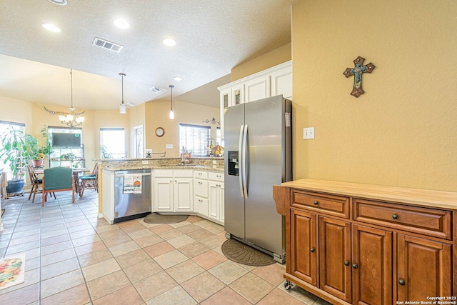 217 Meadowlark Ln, Mcqueeney, TX 78123 - kitchen featuring hanging light fixtures, stainless steel appliances, kitchen peninsula, and white cabinets