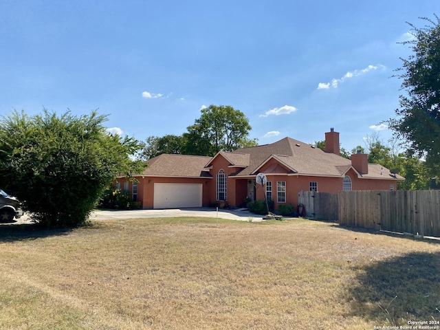 217 Meadowlark Ln, Mcqueeney, TX 78123 - ranch-style house featuring a garage and a front yard