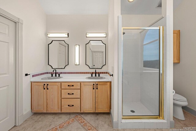 bathroom featuring walk in shower, tile patterned floors, toilet, and vanity