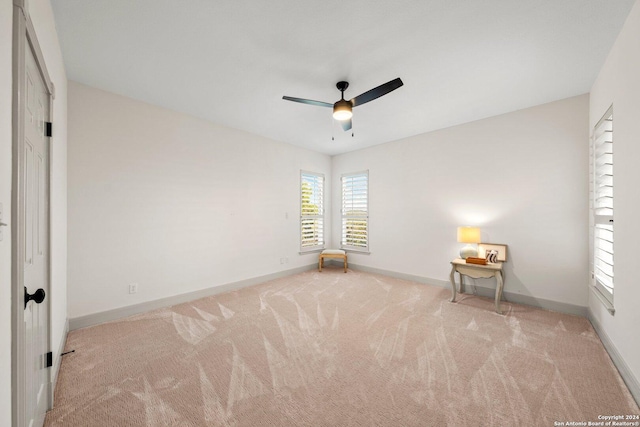 unfurnished bedroom featuring light carpet and ceiling fan