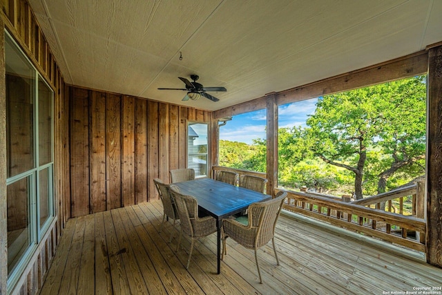 unfurnished sunroom with ceiling fan