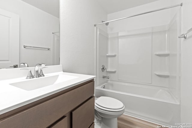 full bathroom with vanity, hardwood / wood-style flooring, toilet, and shower / bath combination