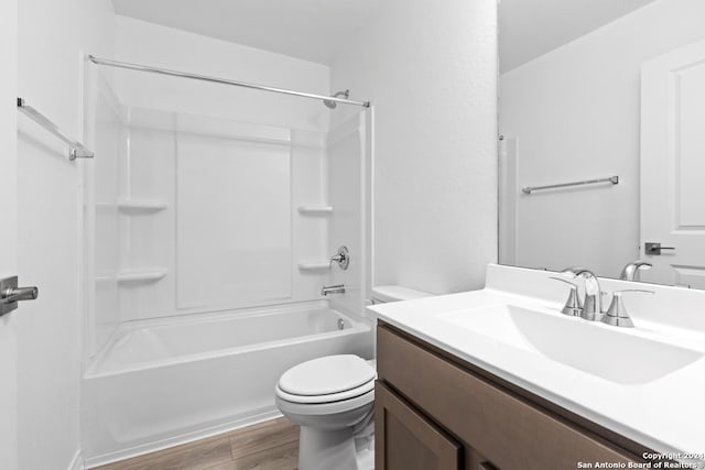 full bathroom with vanity, hardwood / wood-style floors, shower / washtub combination, and toilet