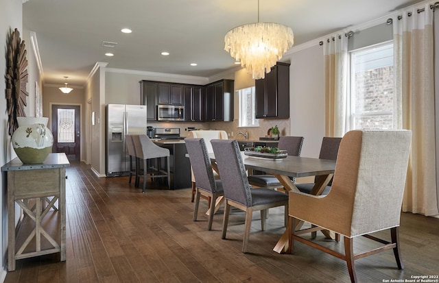 dining space with crown molding, plenty of natural light, and dark hardwood / wood-style flooring