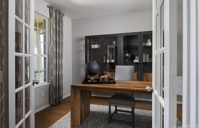 office with dark hardwood / wood-style floors and french doors