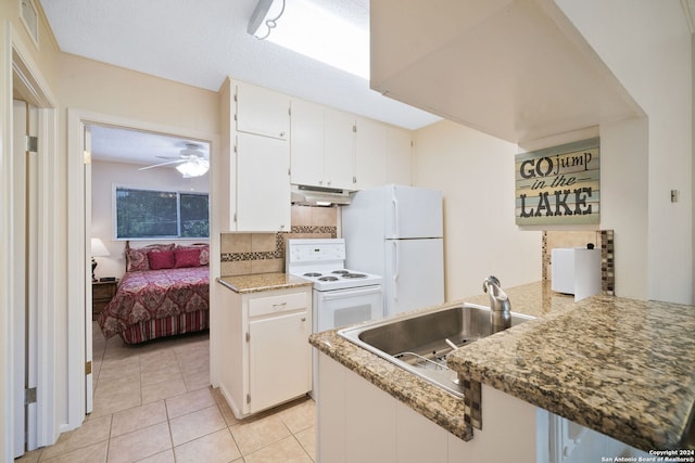kitchen featuring light tile patterned floors, white appliances, a ceiling fan, under cabinet range hood, and a sink