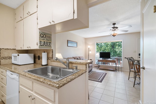kitchen with light tile patterned floors, a sink, open floor plan, ceiling fan, and white appliances