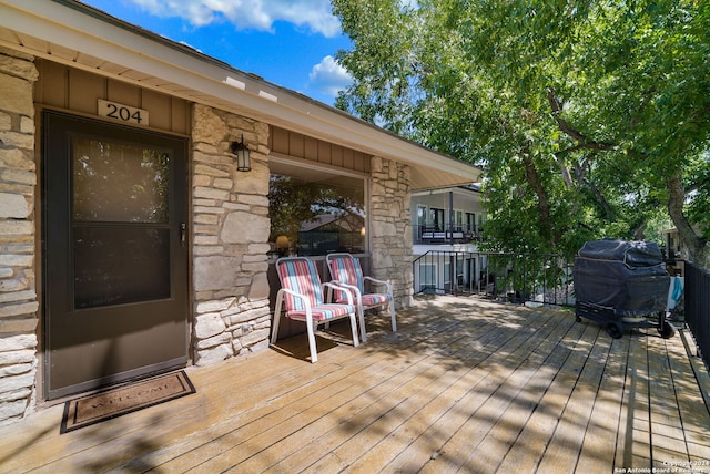 wooden deck with a grill