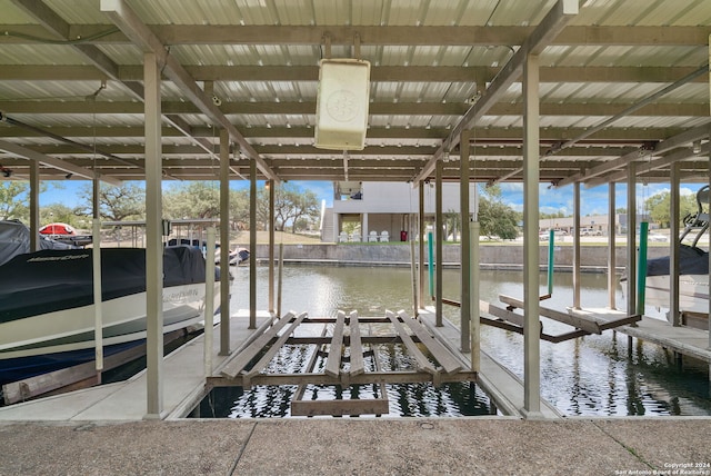 view of dock featuring boat lift and a water view