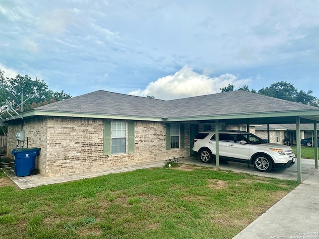 view of home's exterior with a lawn and a carport