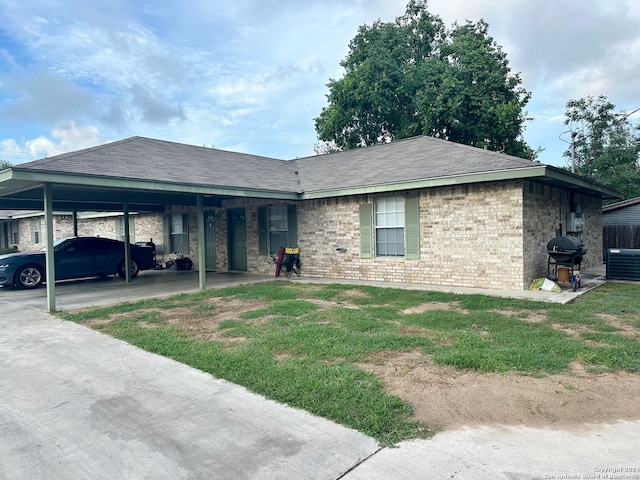 ranch-style home featuring a carport and central AC unit