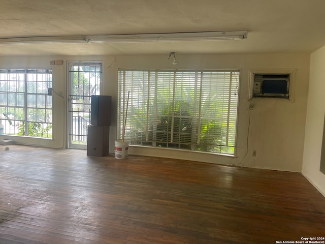 unfurnished room with dark hardwood / wood-style flooring