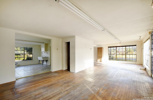 spare room featuring hardwood / wood-style flooring and a sink