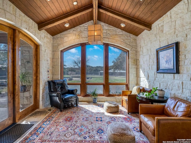 sitting room with wood ceiling and lofted ceiling with beams