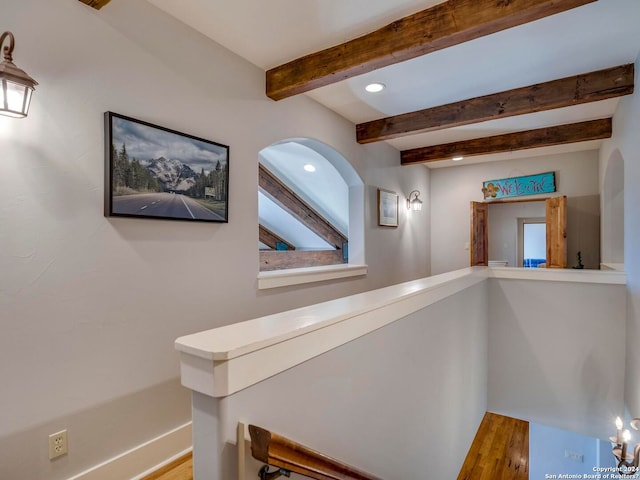 hallway featuring baseboards, recessed lighting, beam ceiling, and light wood-style floors