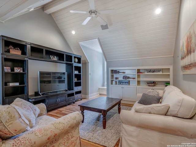 living area with vaulted ceiling with beams, a ceiling fan, baseboards, built in features, and light wood finished floors