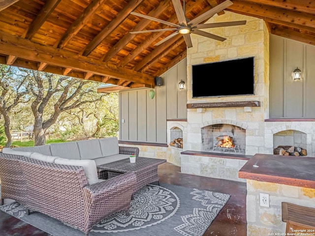 view of patio with an outdoor living space with a fireplace and ceiling fan