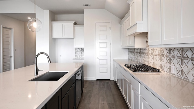 kitchen featuring sink, hanging light fixtures, dark hardwood / wood-style flooring, stainless steel appliances, and white cabinets