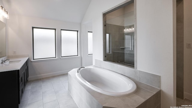 bathroom featuring vaulted ceiling, shower with separate bathtub, vanity, and tile patterned floors