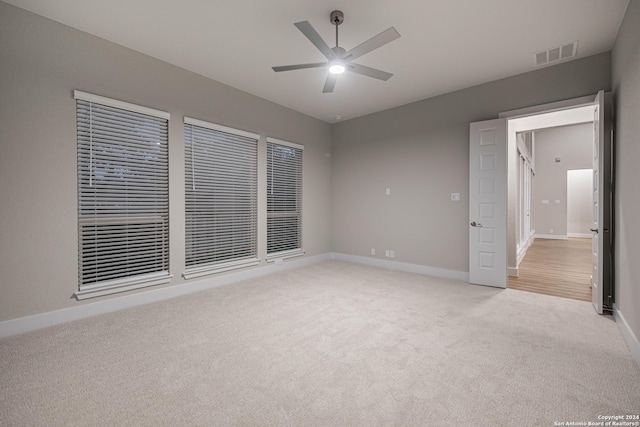 unfurnished bedroom featuring ceiling fan and light colored carpet