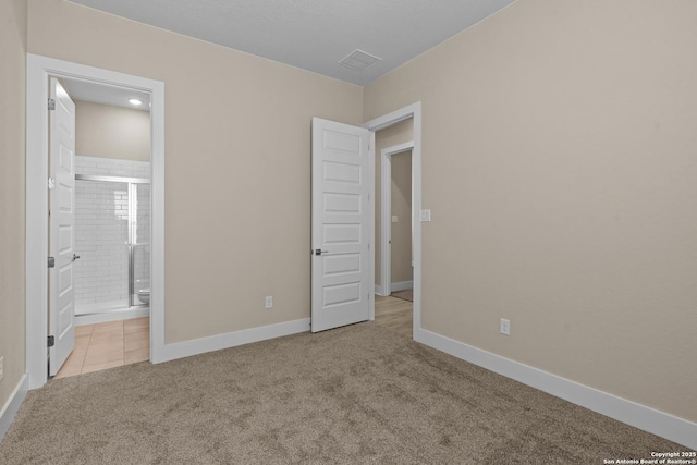 unfurnished bedroom with visible vents, ensuite bathroom, baseboards, and carpet floors