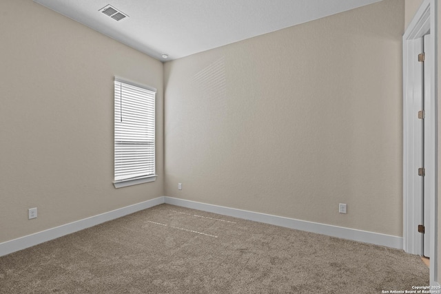 unfurnished room featuring visible vents, baseboards, and carpet