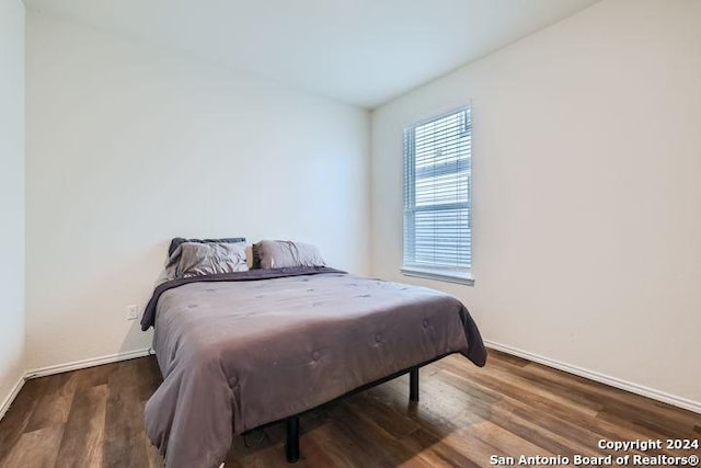 bedroom featuring dark hardwood / wood-style flooring