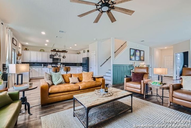 living room featuring hardwood / wood-style flooring and ceiling fan