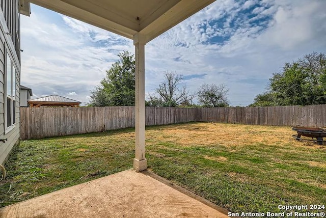 view of yard with an outdoor fire pit