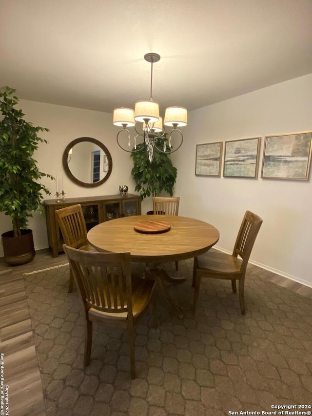 dining room with a chandelier and dark hardwood / wood-style floors