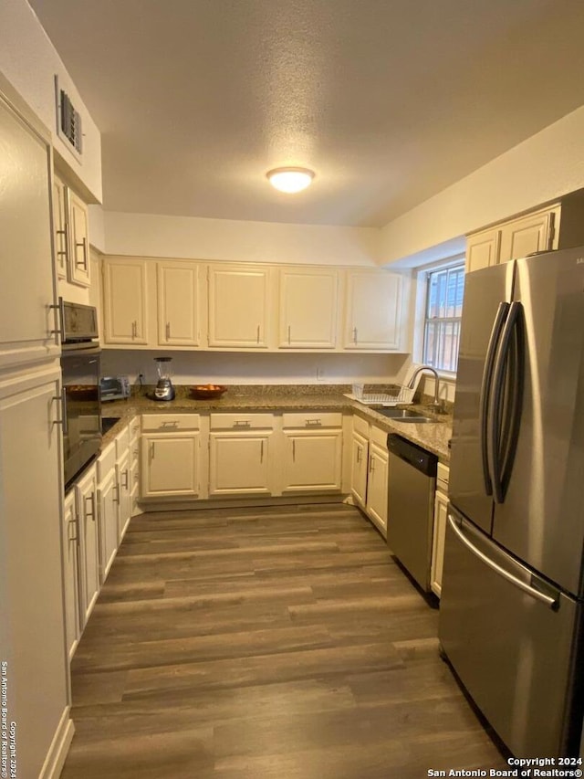 kitchen with white cabinetry, sink, dark wood-type flooring, and stainless steel appliances