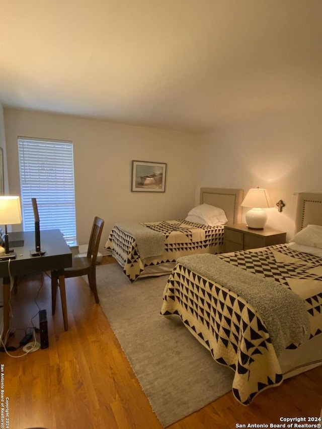 bedroom with hardwood / wood-style flooring