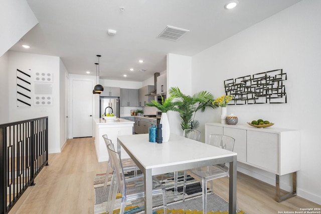 dining area featuring light wood-type flooring