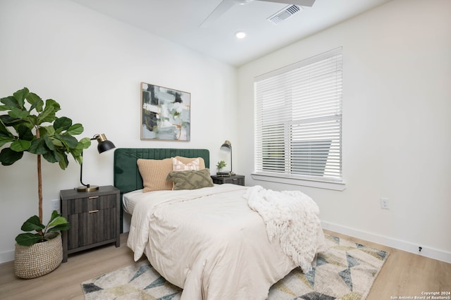 bedroom with ceiling fan and light hardwood / wood-style floors