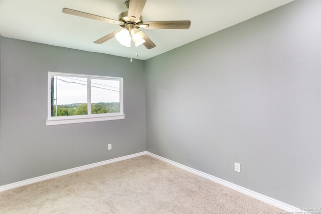 spare room featuring carpet flooring and ceiling fan