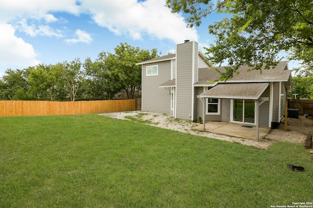 rear view of property featuring a patio and a lawn