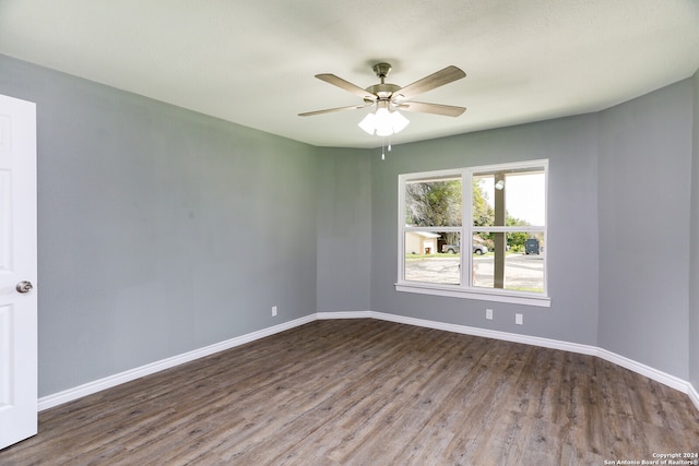 empty room with hardwood / wood-style flooring and ceiling fan